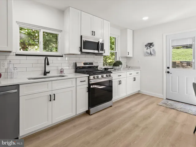 a view of a bathroom with a tub and a shower