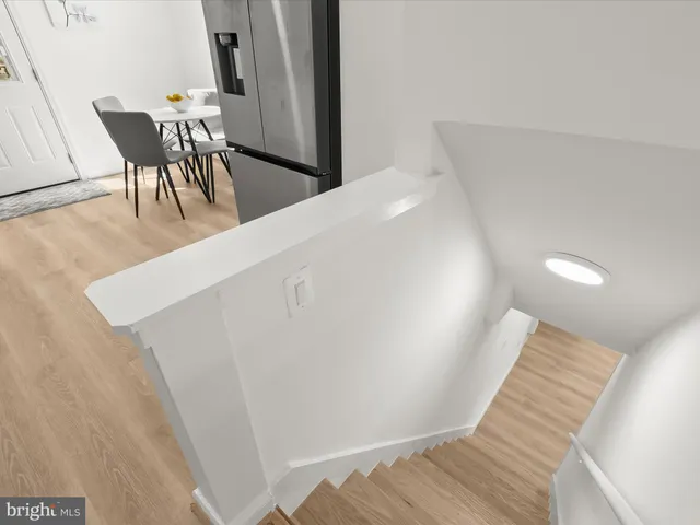 a bedroom with a bed and a lamp on the dresser