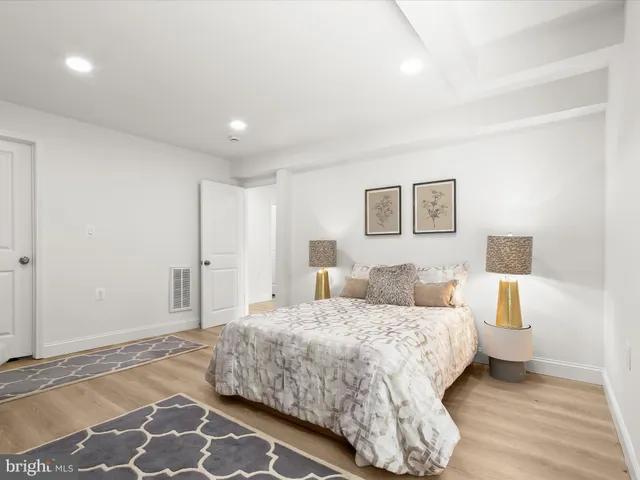 a view of a house with a big yard potted plants and large tree