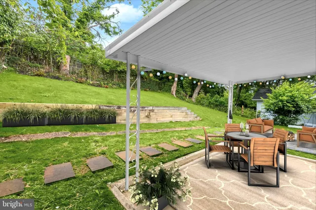 a front view of a house with a garden and plants