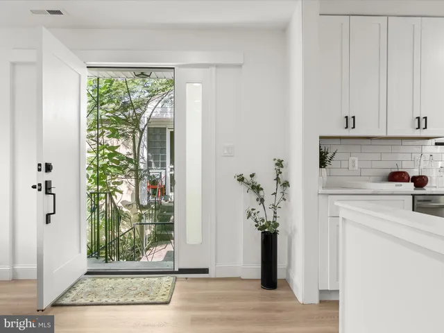 a living room with furniture and a dining table with kitchen view
