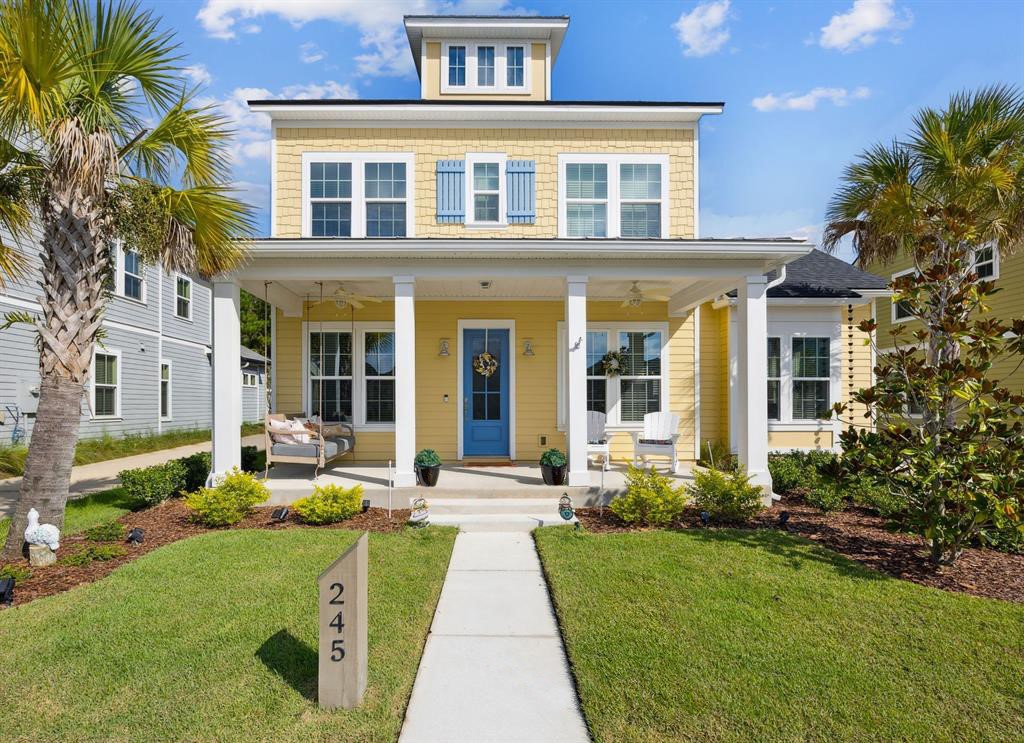 a front view of a house with garden and porch