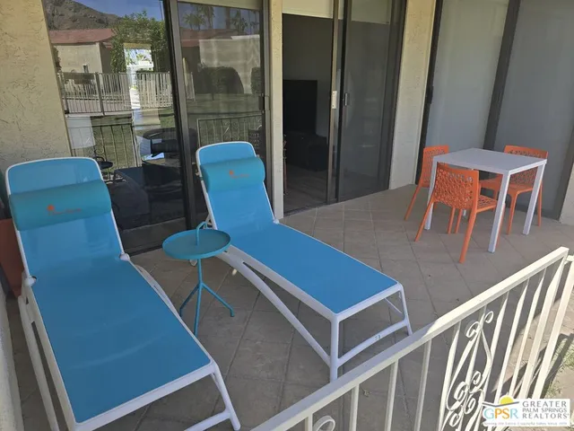 a blue chair sitting in front of a building