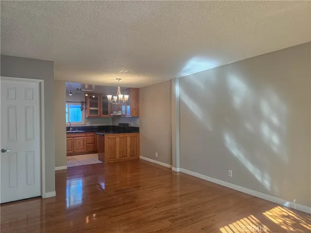 a kitchen with stainless steel appliances kitchen island granite countertop a refrigerator and a stove
