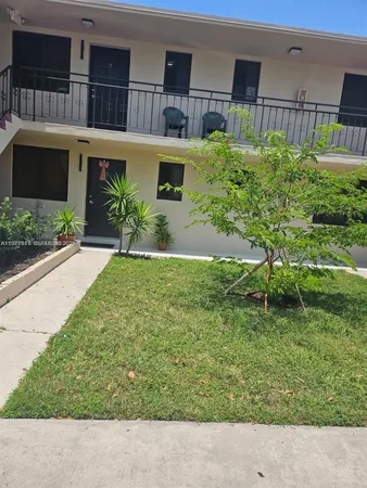 a backyard of a house with a garden and plants