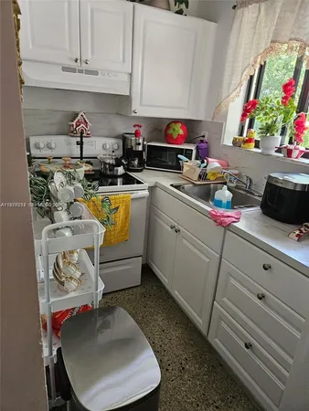 a kitchen with a sink and cabinets
