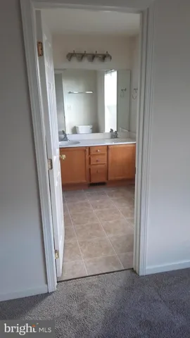 a view of bathroom with mirror and window