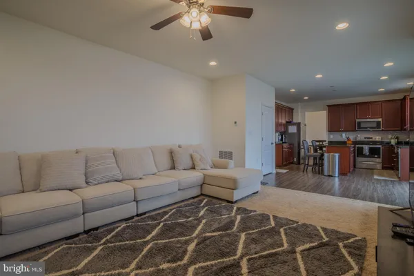 a living room with furniture and kitchen view