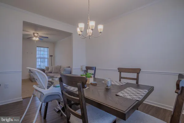 a living room with furniture a flat screen tv and a window
