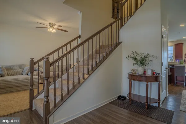 a living room with furniture and a dining table with painted walls