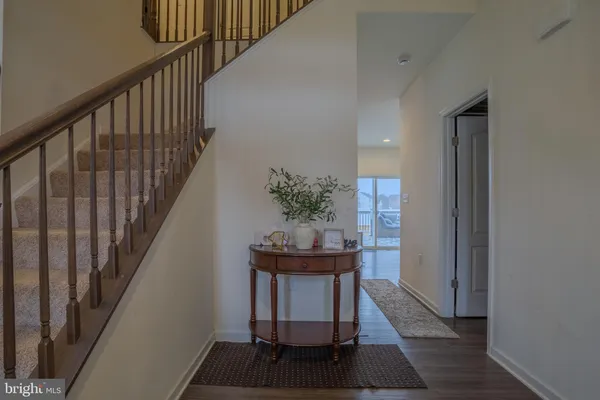 a view of entryway and hall with wooden floor