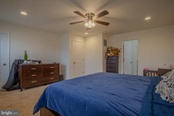 a bedroom with a bed and a dresser