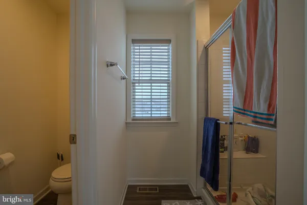 a bathroom with a toilet and a shower