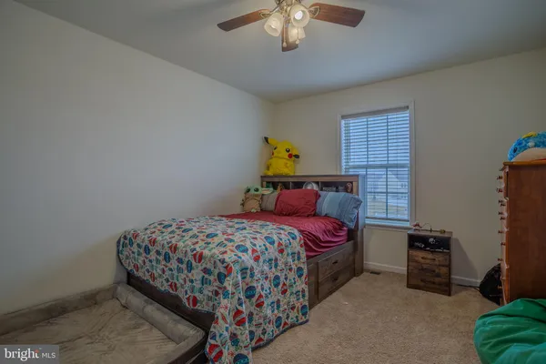 a bedroom with a bed a chandelier and closet