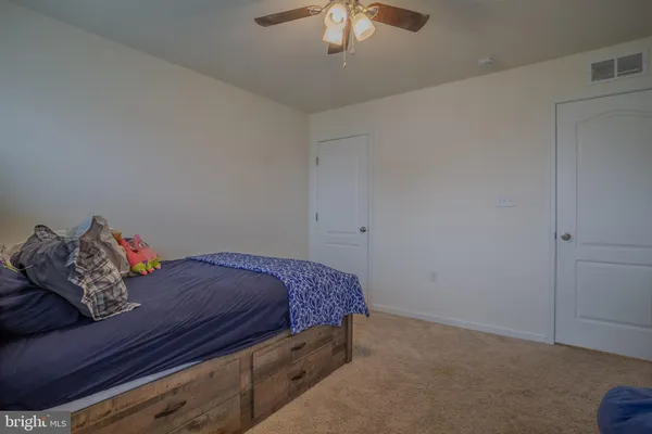 a bed sitting in a bedroom next to a chandelier
