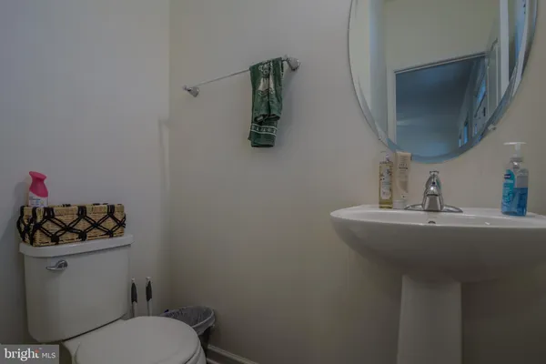 a bathroom with a sink mirror vanity and toilet