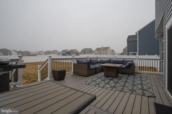 a terrace with a bench and trees