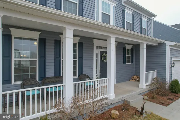front view of a brick house with a small yard