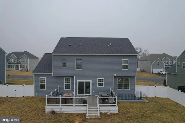 a view of a house with backyard porch and sitting area