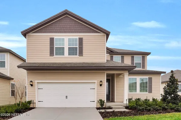 a front view of a house with garage