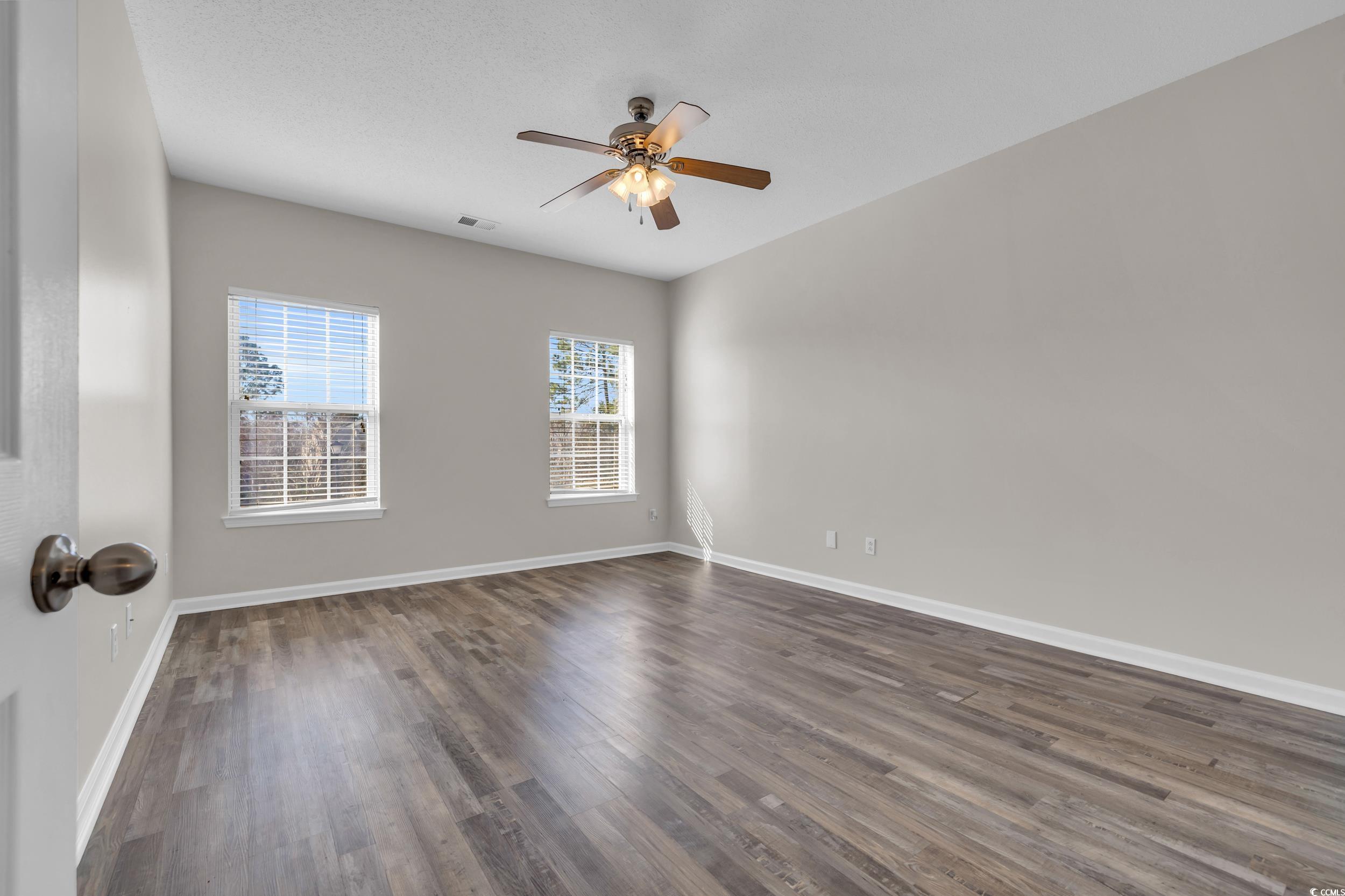 4545 Girvan Drive, Unit E Myrtle Beach, SC 29579 - Photo 13 of 27 Empty room with dark hardwood / wood-style floors