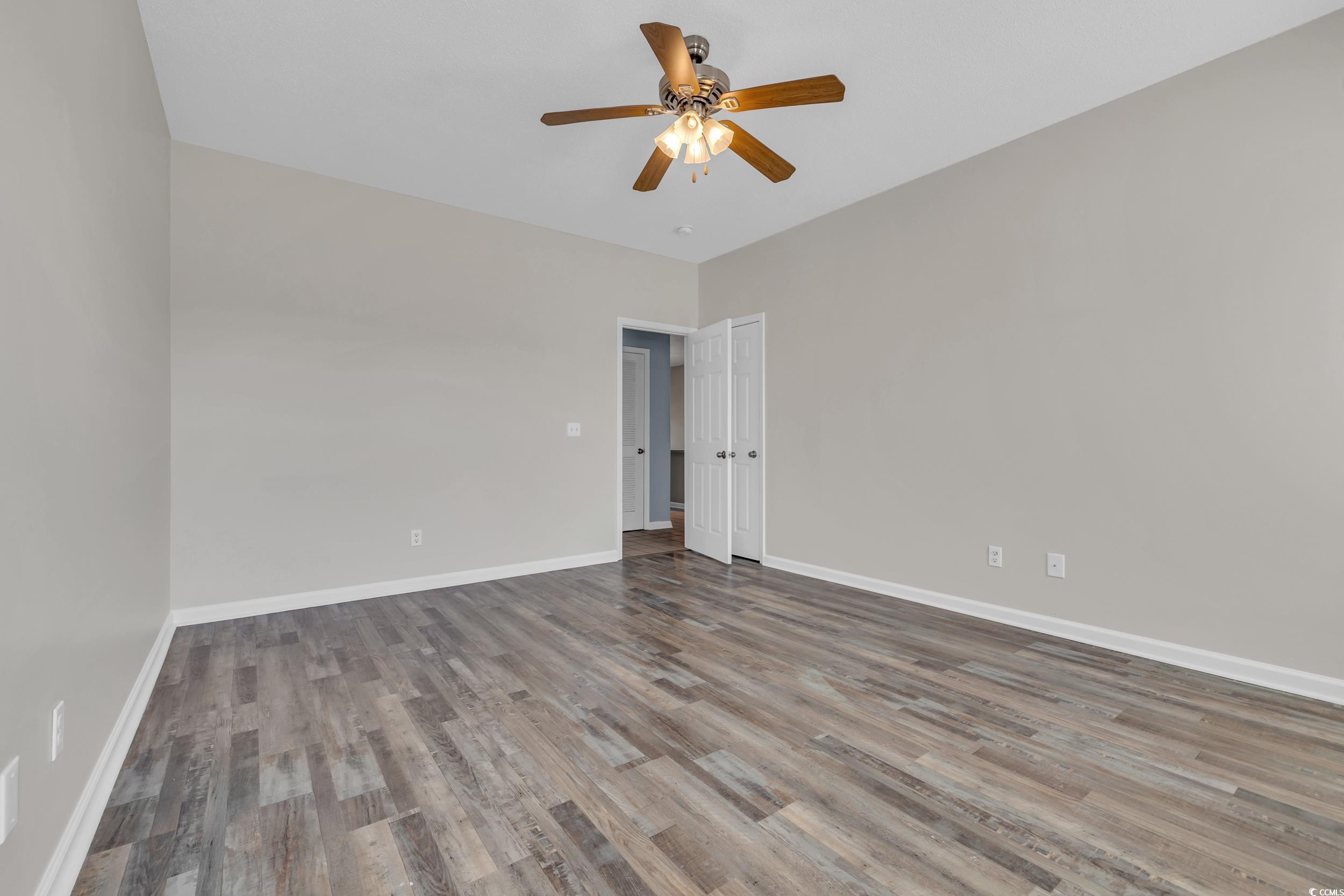 4545 Girvan Drive, Unit E Myrtle Beach, SC 29579 - Photo 14 of 27 Spare room with wood-type flooring and ceiling fan
