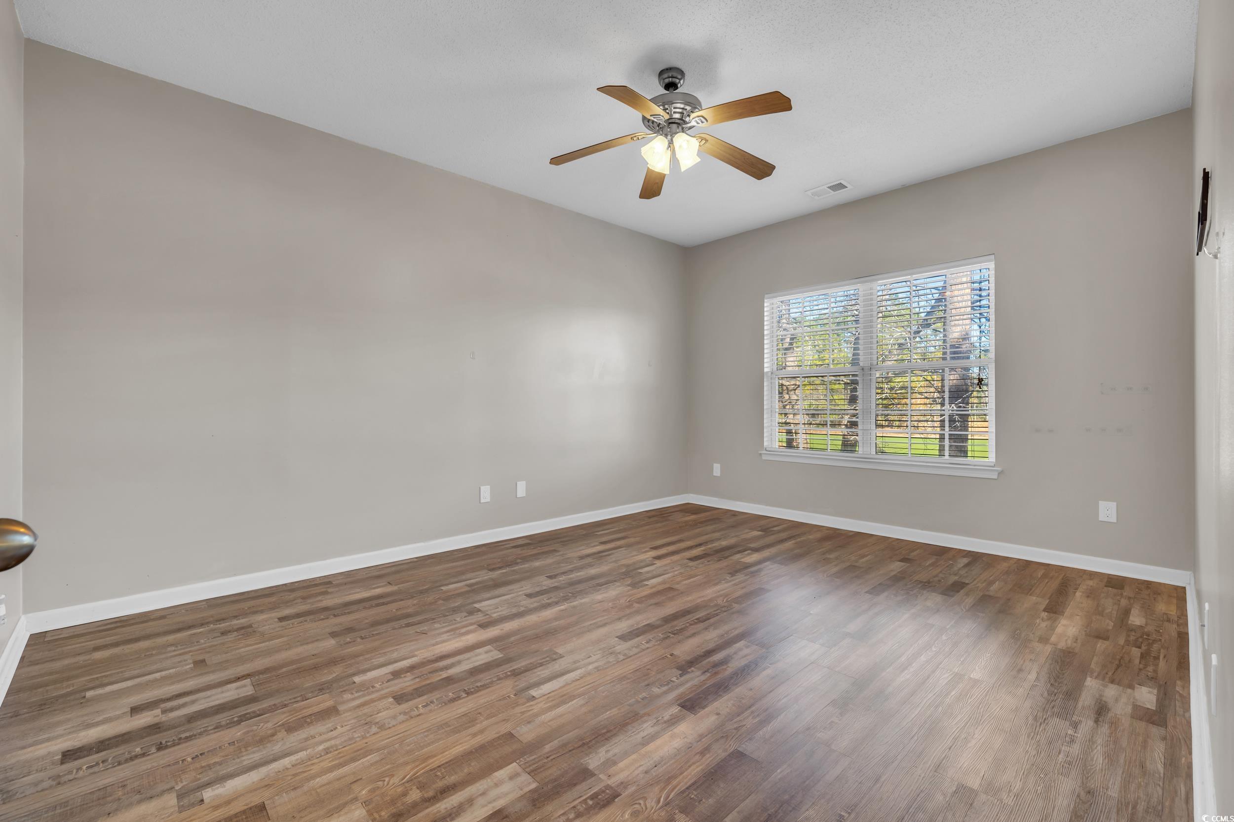 4545 Girvan Drive, Unit E Myrtle Beach, SC 29579 - Photo 16 of 27 Unfurnished room with hardwood / wood-style floori