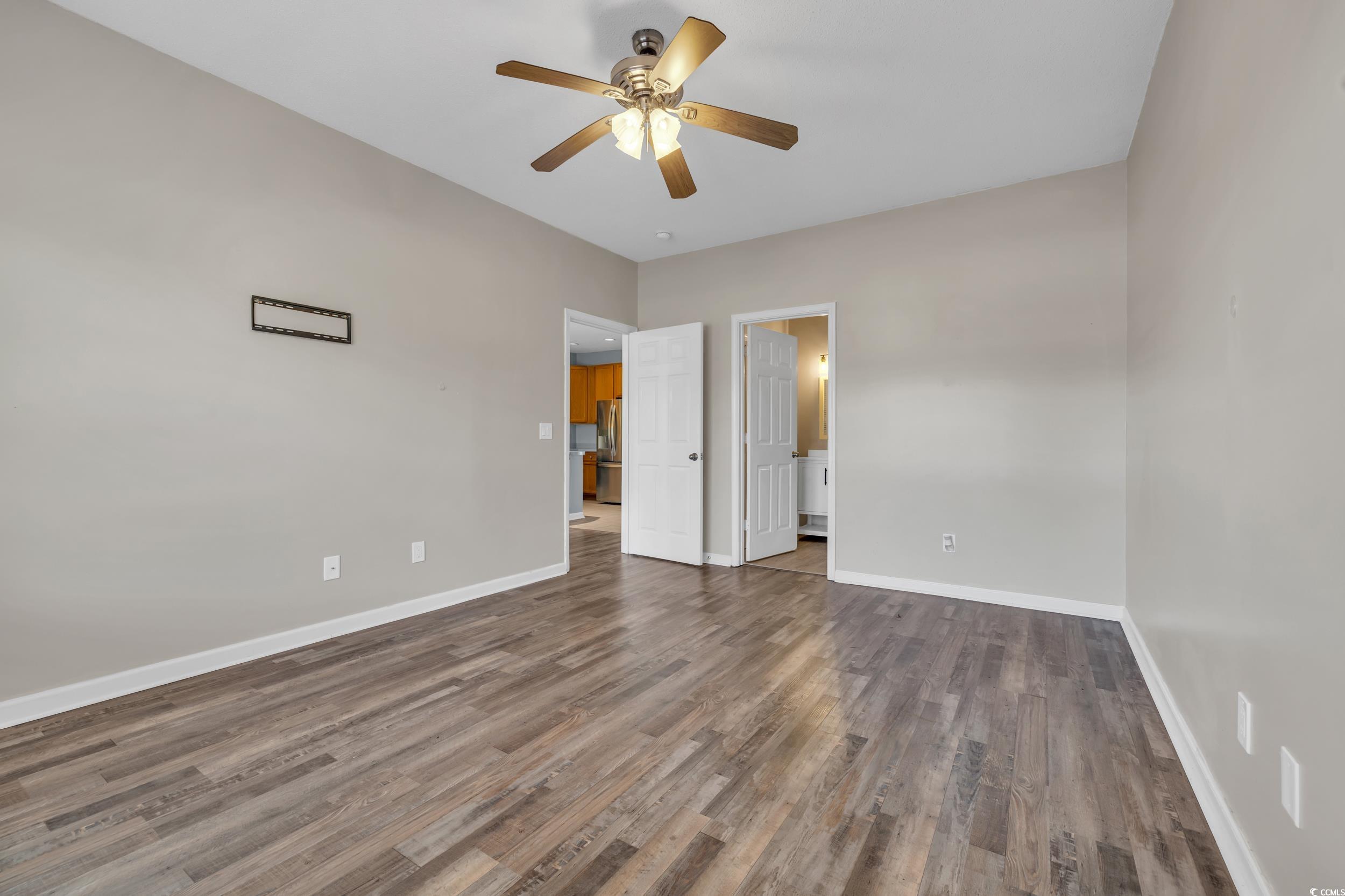 4545 Girvan Drive, Unit E Myrtle Beach, SC 29579 - Photo 17 of 27 Unfurnished bedroom featuring ceiling fan, dark wo