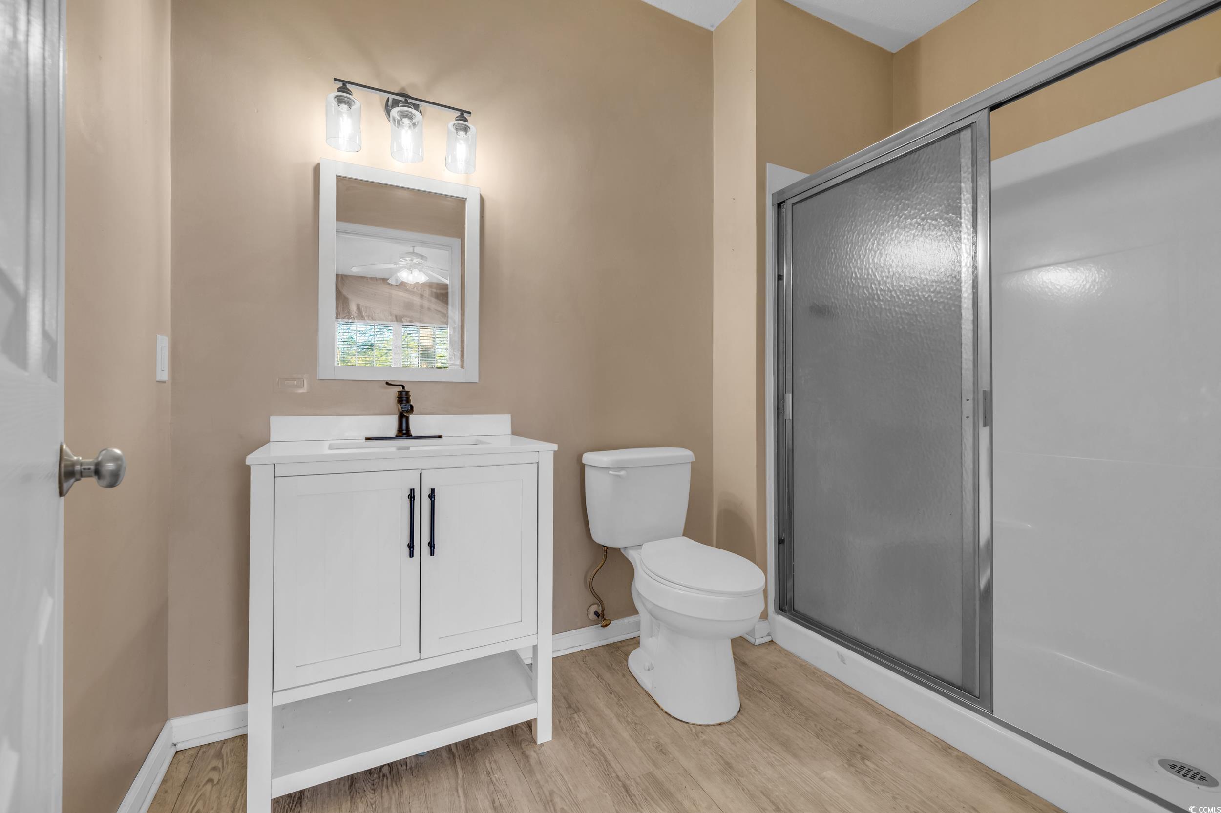 4545 Girvan Drive, Unit E Myrtle Beach, SC 29579 - Photo 26 of 27 Bathroom featuring wood-type flooring, vanity, toi