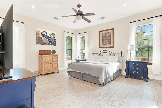 a spacious bedroom with a bed and a desk