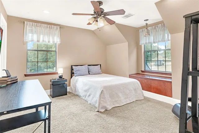 a bedroom with a large bed and a chandelier