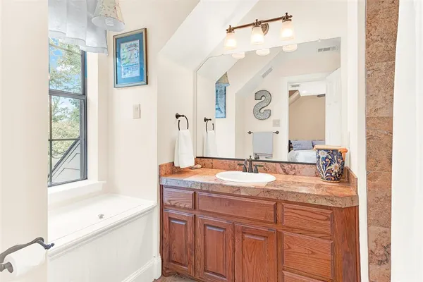 a bathroom with a granite countertop sink mirror and a