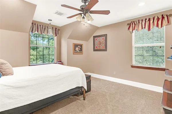 a bed sitting in a bedroom next to a window