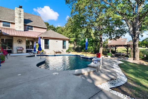a view of a house with sitting area and a yard