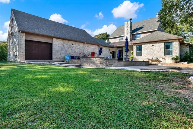a house view with a sitting space and garden space