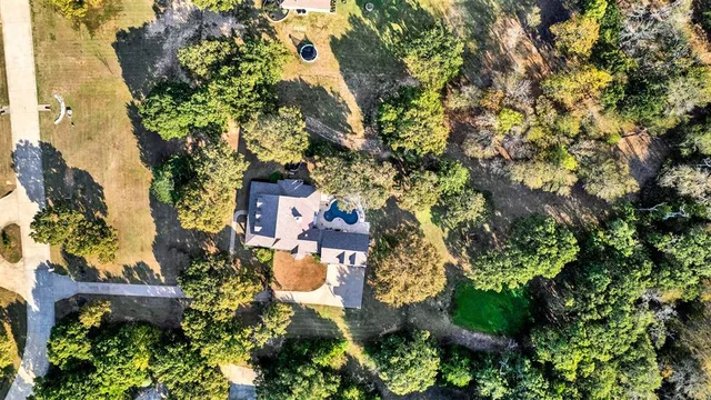 an aerial view of a house with yard and outdoor seating