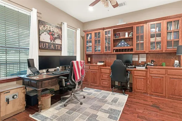a view of a workspace with furniture and a window