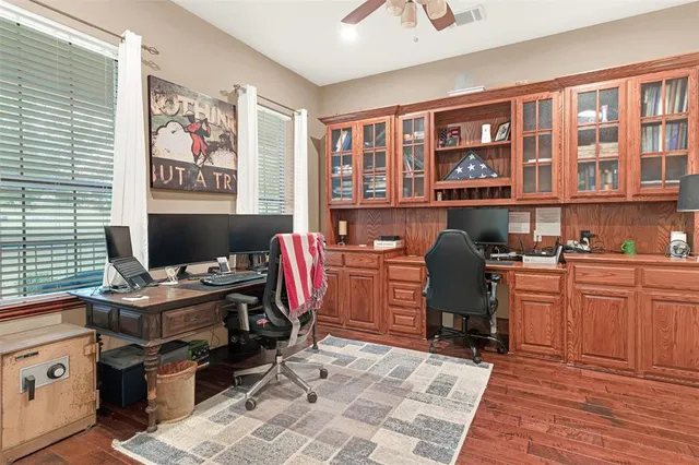 a view of a workspace with furniture and a window