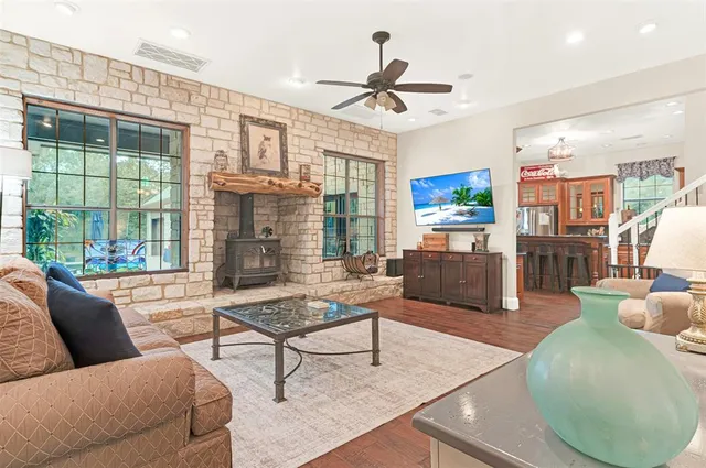 a living room with furniture and a floor to ceiling window