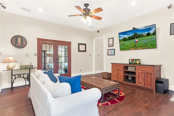 a living room with furniture kitchen view and a flat screen tv