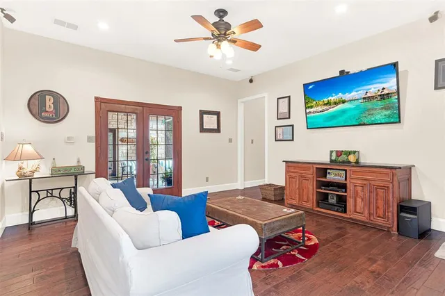a living room with furniture kitchen view and a window