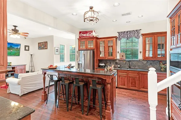 a kitchen that has a table chairs in it and wooden floors