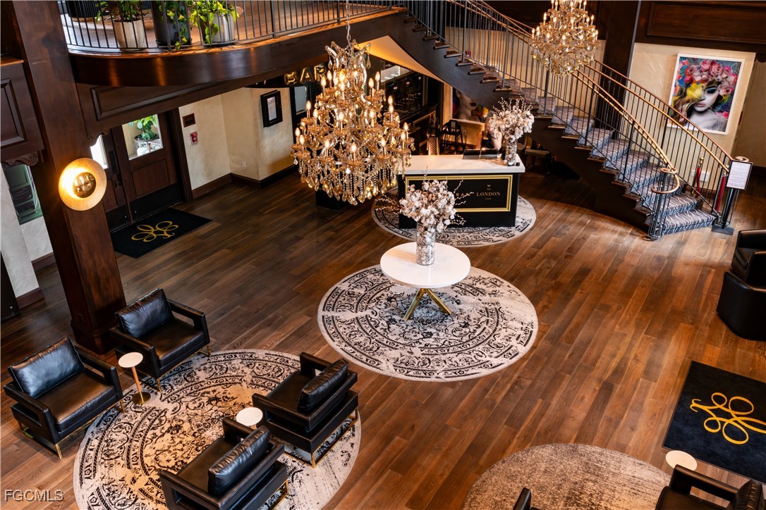 221 9th Street South, Unit 207 Naples, FL 34102 - Photo 2 of 38 a living room with furniture and a fireplace