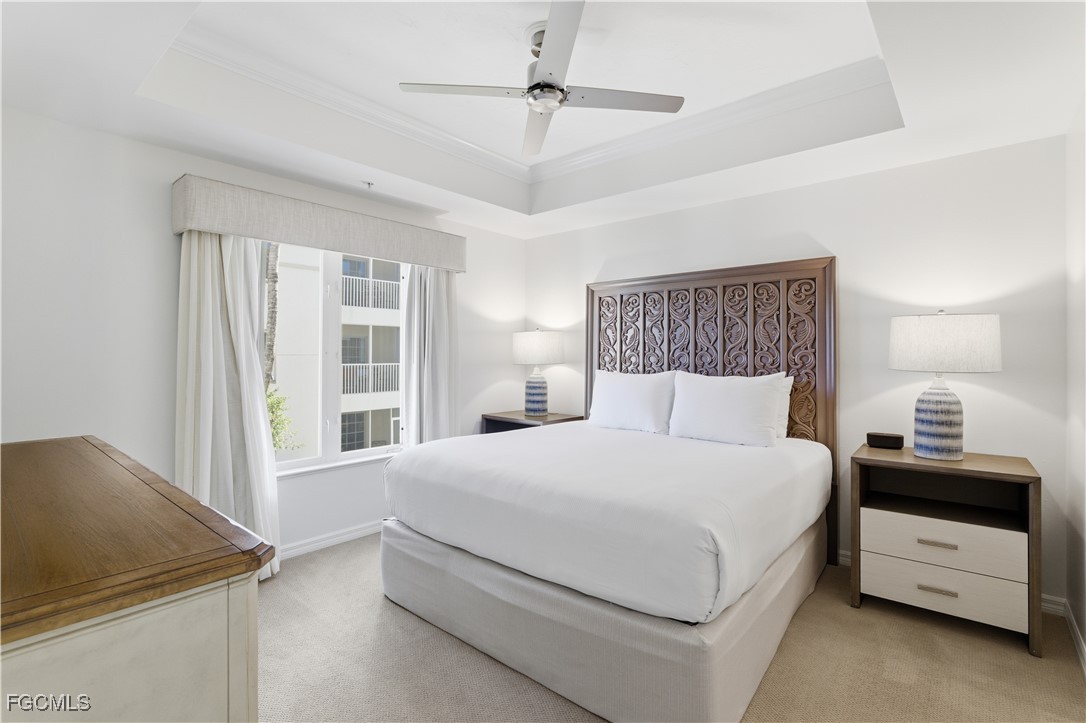 221 9th Street South, Unit 207 Naples, FL 34102 - Photo 27 of 38 a bedroom with a bed and a ceiling fan