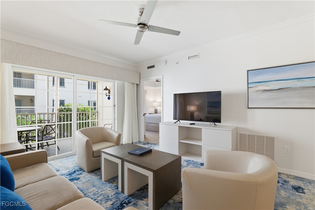 221 9th Street South, Unit 207 Naples, FL 34102 - Photo 3 of 38 a living room with furniture a flat screen tv and a large window