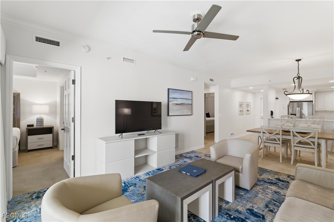 221 9th Street South, Unit 207 Naples, FL 34102 - Photo 4 of 38 a living room with furniture and a flat screen tv