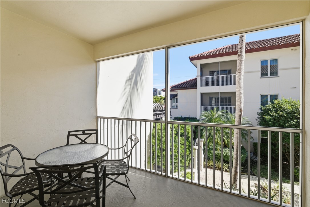 221 9th Street South, Unit 207 Naples, FL 34102 - Photo 7 of 38 a view of a chair and table in the balcony