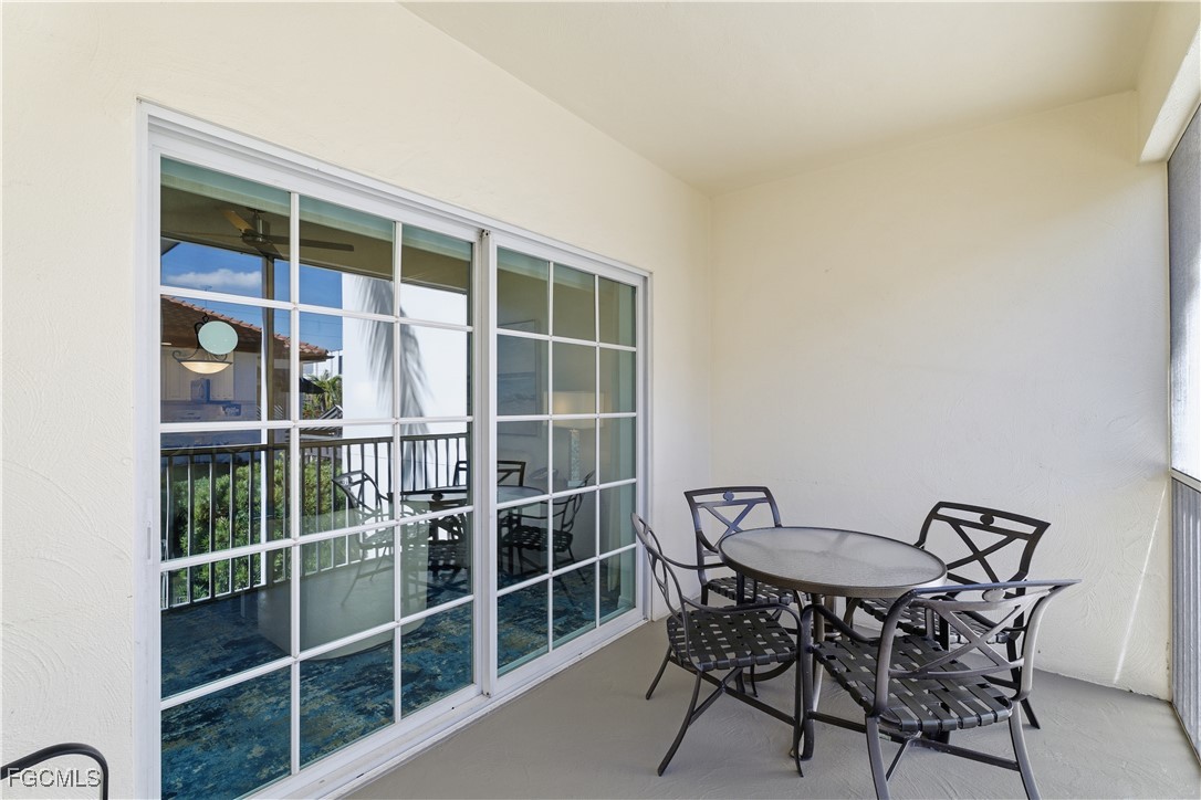221 9th Street South, Unit 207 Naples, FL 34102 - Photo 8 of 38 a view of a chair and table in a room