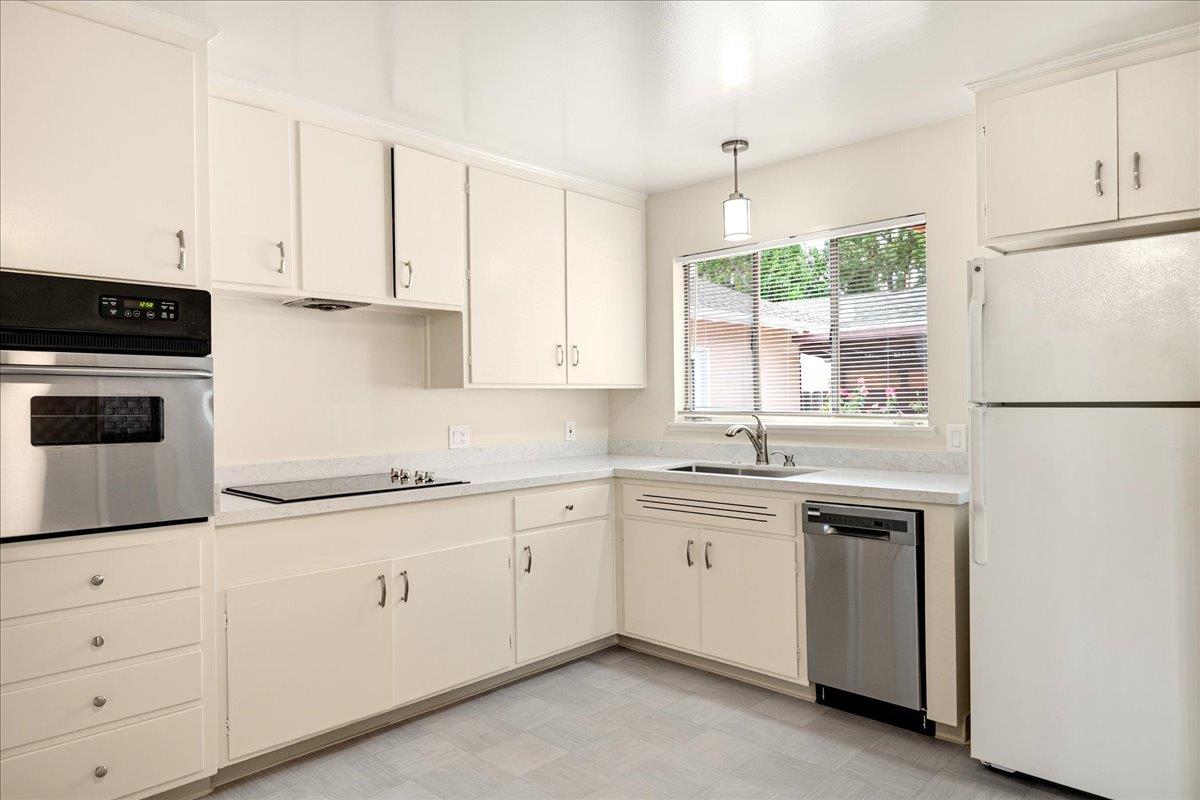 1198 Boranda Avenue Mountain View, CA 94040 - Photo 12 of 38 a kitchen with granite countertop white cabinets and white appliances