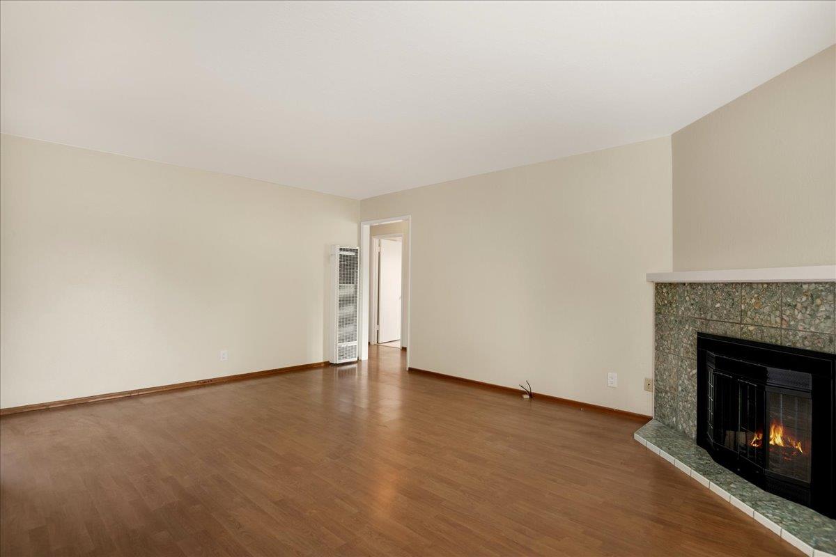 1198 Boranda Avenue Mountain View, CA 94040 - Photo 17 of 38 a view of an empty room with wooden floor and a fireplace